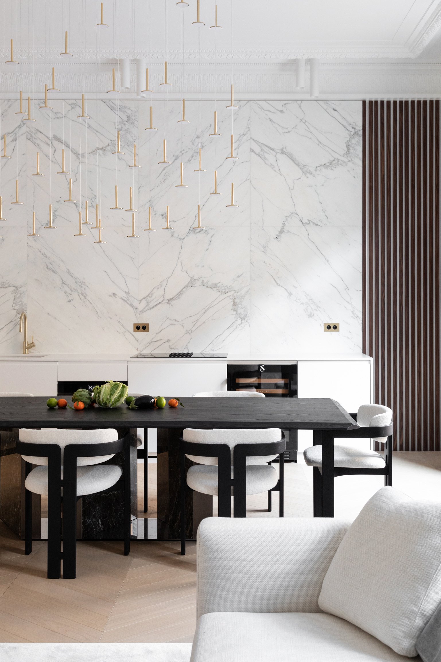 Calacatta marble detail and brass pendants — Paris 1st
