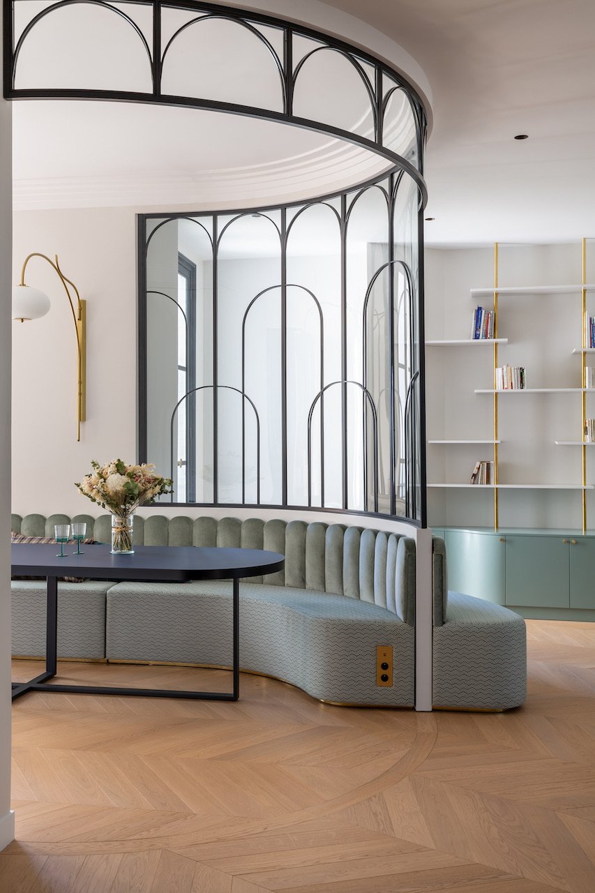 Curved banquette and brass bookcase — Paris 16th