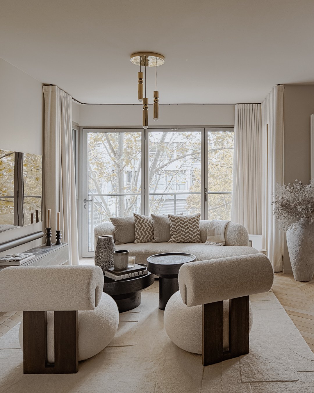 Living room boucle armchairs and brass pendant — Paris 7th