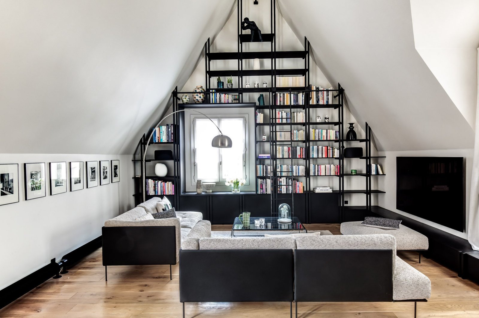 Living room metal bookcase under the rooftops — Le Marais